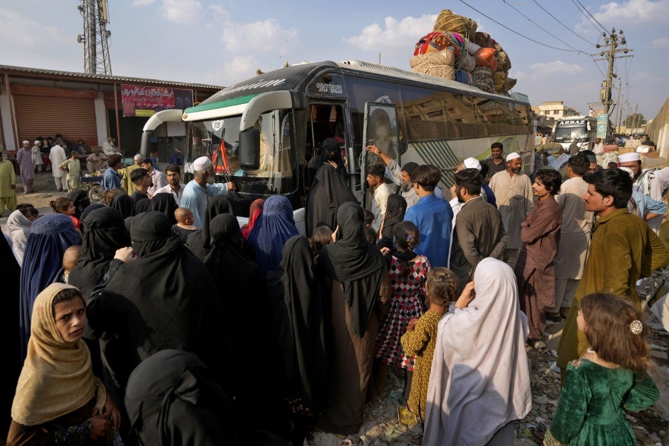 People board a bus to depart for Afghanistan, in Karachi, Pakistan, October 31, 2023.