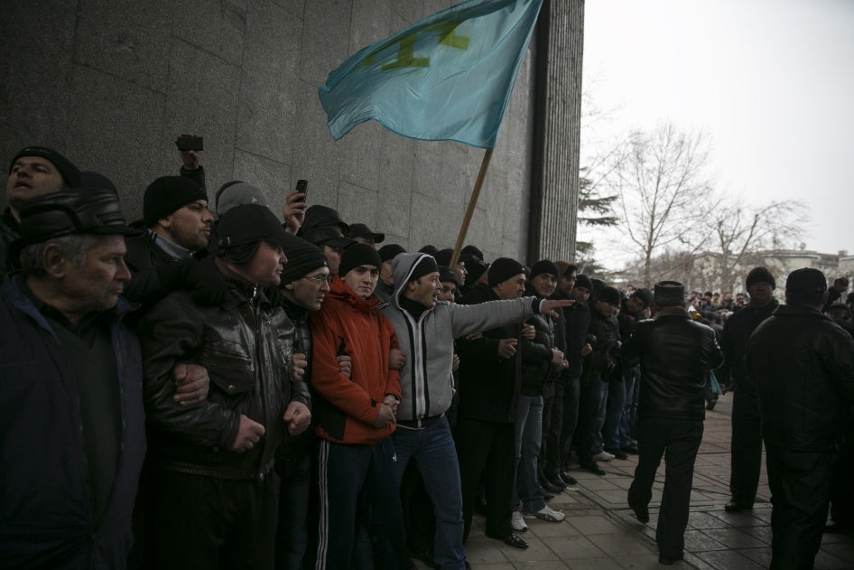 Crimean Tatars holding their flag during rallies near the Crimean parliament building on February 26, 2014, in the early days of Russia’s invasion of Crimea. 