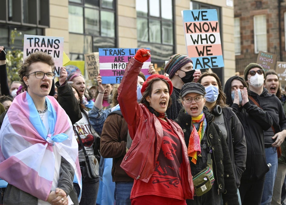 People from trans rights groups and community organizations take part in a rally following the Supreme Court ruling on the definition of a woman in equalities law.  