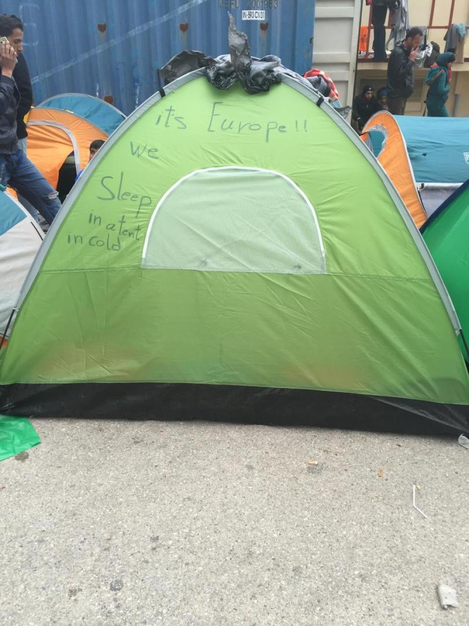 “It’s Europe!! We sleep in a tent in cold”: Writing on a tent at a makeshift camp for asylum seekers and migrants at the port of Piraeus, in Athens. An estimated 44,000 people are trapped in Greece  as a result of Western Balkan  border closures, March 16