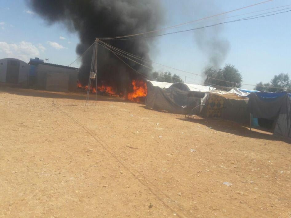 Shelters burning in Iqdah displaced persons camp near the closed Turkish border north of Aleppo after ISIS took over the camp on April 14. 