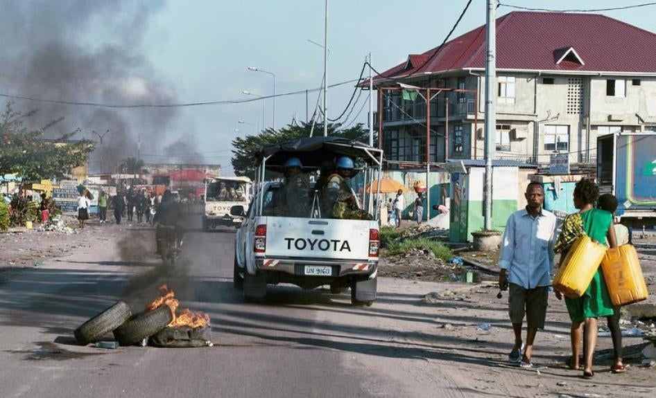 Peacekeepers serving in the UN peacekeeping mission in Congo (MONUSCO) drive past burning tyres as they patrol during protests against the failed implementation of the New Year’s Eve agreement, in Kinshasa, Democratic Republic of Congo, April 10, 2017.