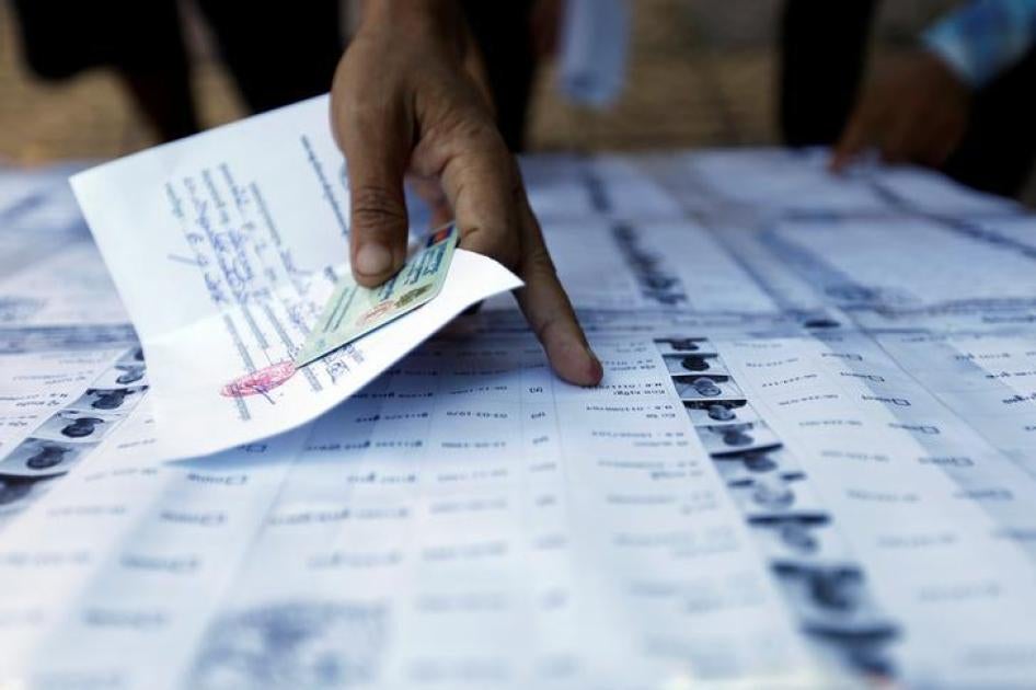 People search for their names on a voting list during commune elections in Phnom Penh, Cambodia, June 4, 2017.