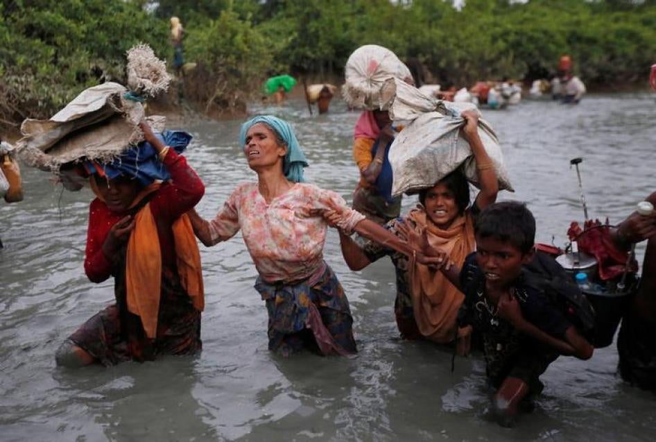 Une famille de Rohingyas fuyant la Birmanie (Myanmar) traverse la rivière Naf, afin d'atteindre le village de Palong Khali au Bangladesh, de l'autre côté de la frontière, le 1er novembre 2017.