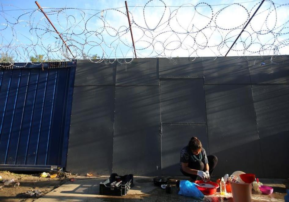 A refugee washes clothes on the Hungary-Serbia border, on the Serbian side of a transit zone set up by Hungarian authorities to filter refugees at Roszke, Hungary, September 2, 2016. 