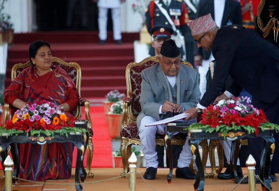 Nepal’s Prime Minister Khadga Prasad Oli signs the oath of office papers next to President Bidhya Devi Bhandari in Kathmandu, Nepal, February 15, 2018.