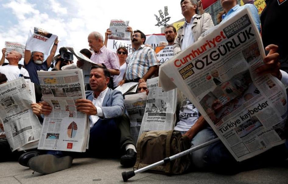Press freedom activists read opposition newspaper Cumhuriyet during a demonstration in solidarity with the jailed members of the newspaper outside a courthouse, in Istanbul, Turkey, July 28, 2017. 