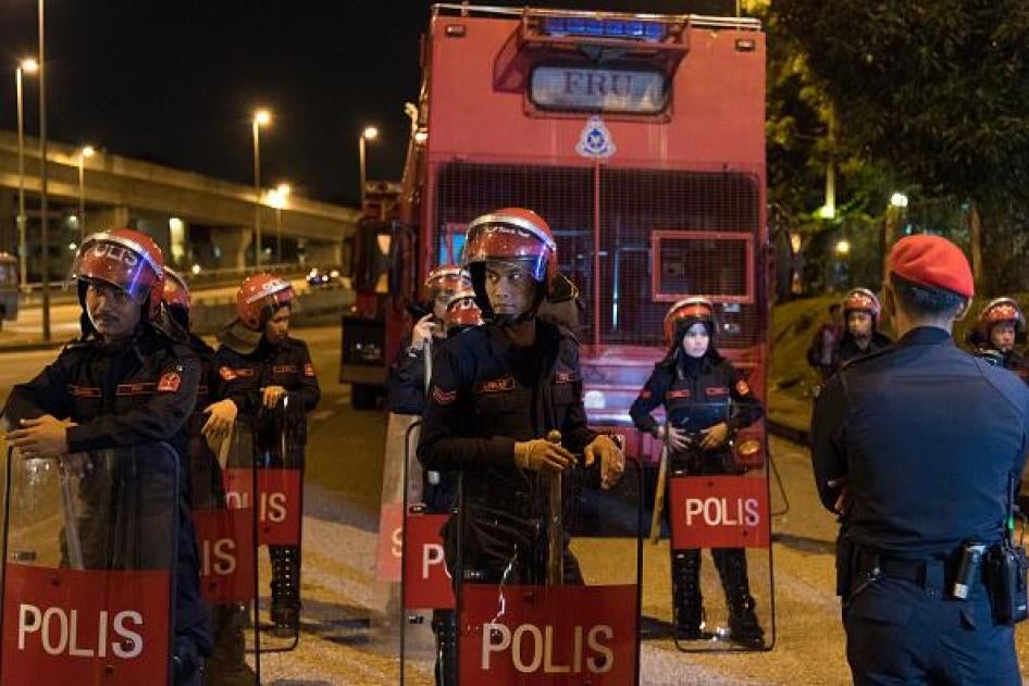 Riot police members stand guard at the Seafield temple on November 27, 2018 in Subang Jaya, Selangor, Malaysia. The priest says there are criminal elements involved in the attack on the temple yesterday. Temple chief priest Jeyakumar Subramaniam said he s
