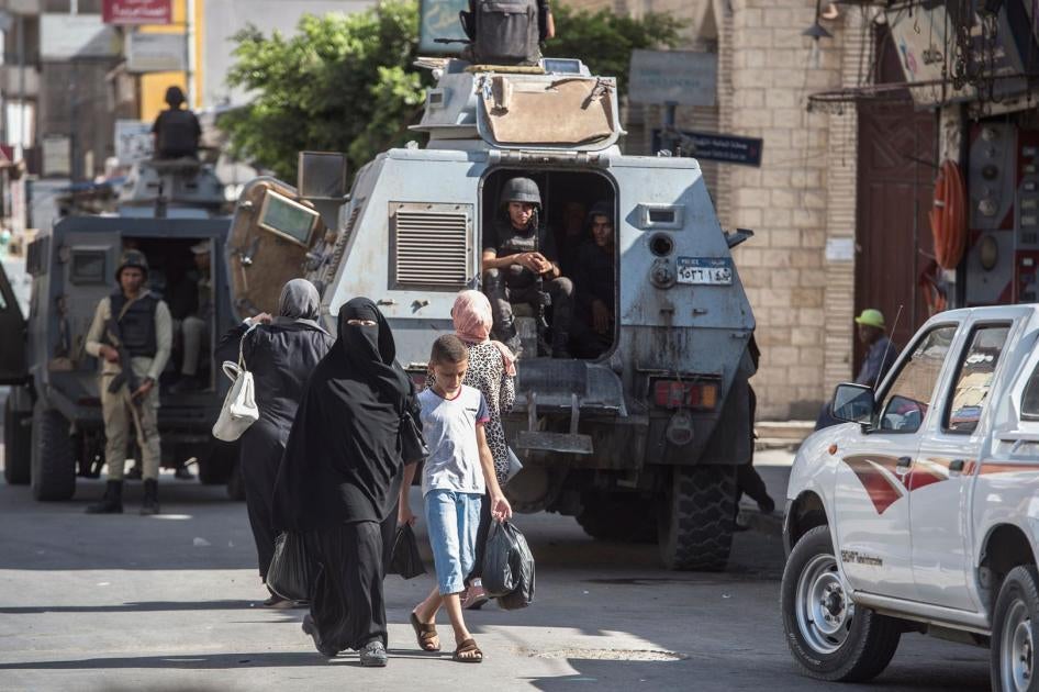 A picture taken on July 26, 2018 shows Egyptian policemen stand guarding a street in the North Sinai provincial capital of El-Arish. With fruit and vegetables aplenty in the markets, public transport back on the roads and universities reopened, life is re