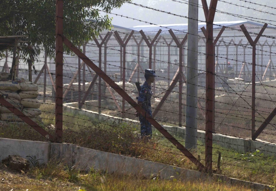 A police officer stands guard outside repatriation camps built for Rohingya refugees expected to return from Bangladesh, in northern Rakhine State, Myanmar, January 24, 2018.