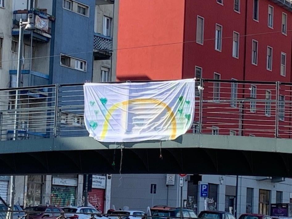 A homemade sign hanging on a bridge over one of Milan’s canals with the slogan, "Tutto Andrà Bene" ("Everything Will Be OK"), March 15, 2020.