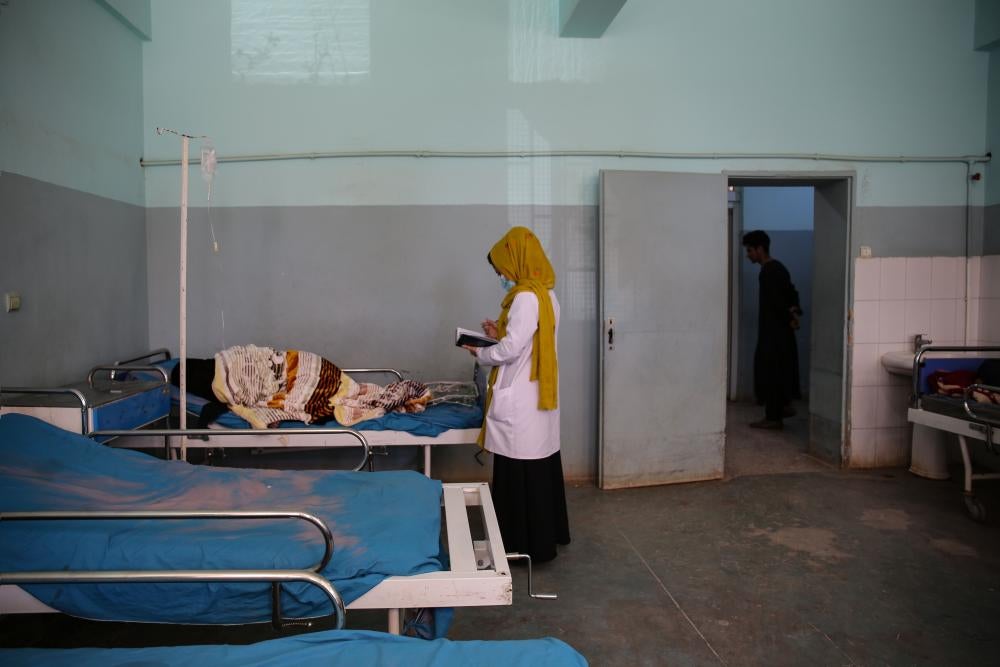 A psychiatrist meets with a female patient in a mental health ward