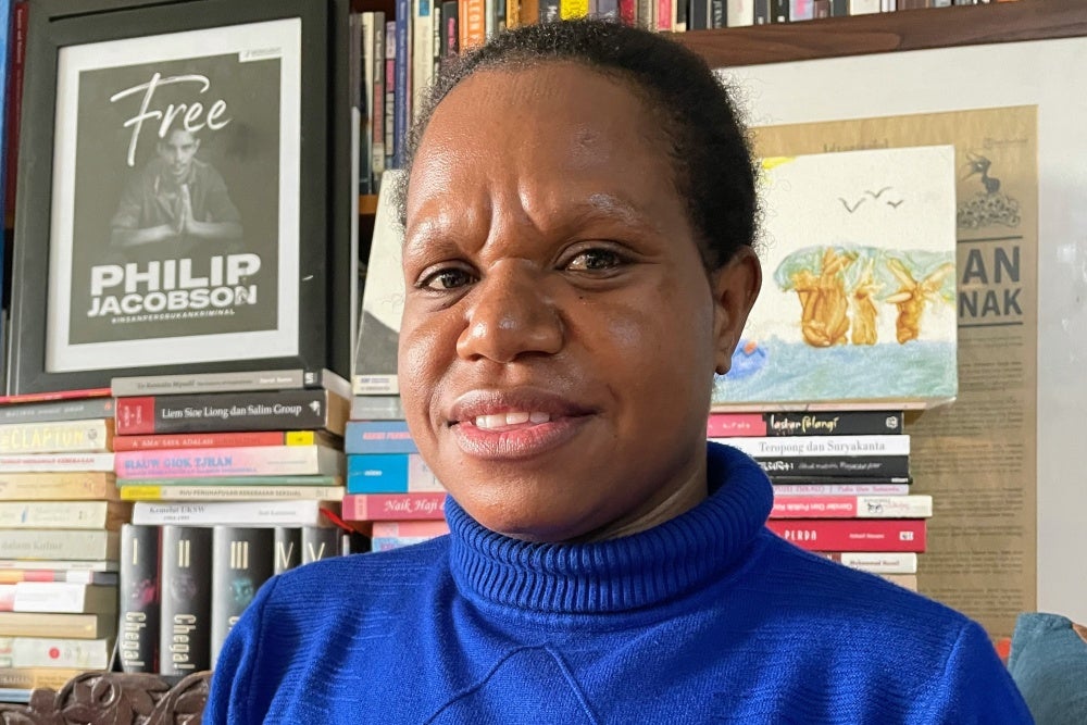 A woman gives two thumbs up 