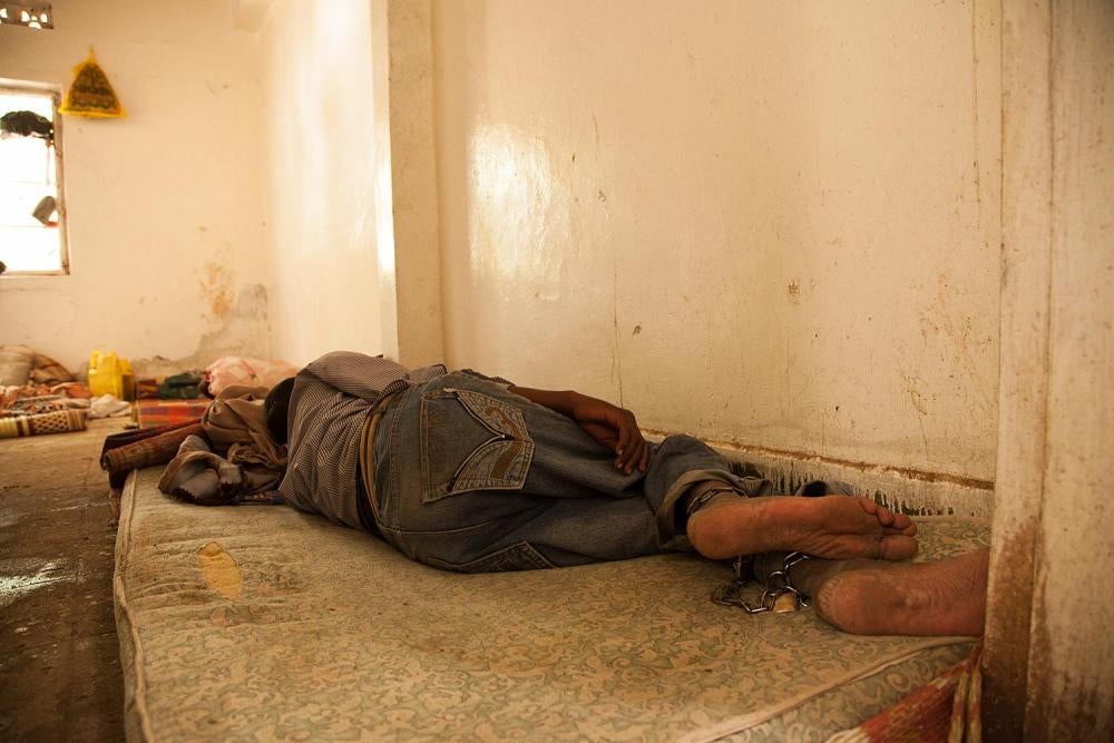 patient sleeps with his feet chained