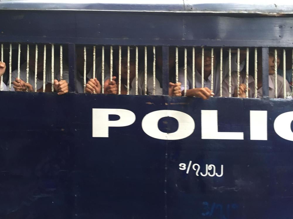 Police vans bring detained student protesters from the district courthouse to Tharrawaddy prison in Pegu region on October 27, 2015. 