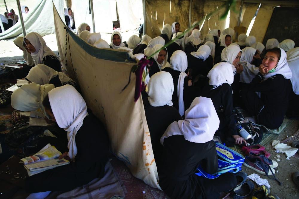 Two classes take place back-to-back with only a cloth partition separating them.