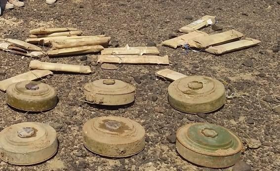 Anti-vehicle mines with pressure plates that have been modified to be triggered by a person.