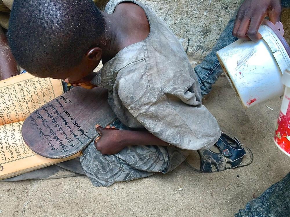 A talibé child studies the Quran at a daara in Diourbel, Senegal, June 24, 2018.  