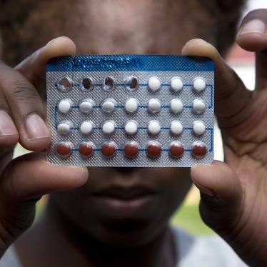 A woman holds a packet of contraceptive pills, in Harare, Thursday, April 9, 2020.