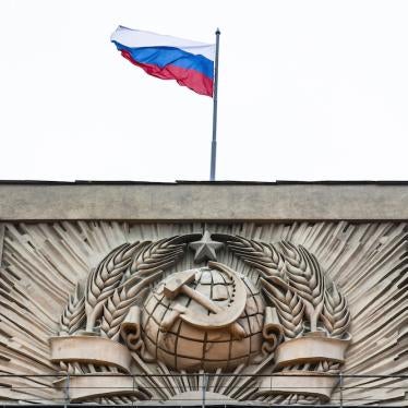 A Russian state flag waves on top of a hammer and sickle at the State Duma, lower parliament chamber, headquarters in Moscow, Russia