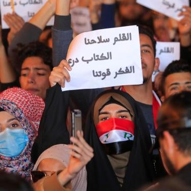 Woman holding up a sign in Arabic
