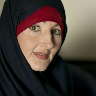 A woman poses wearing a hijab