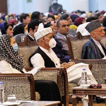 Afghan President Ashraf Ghani, center left, wears a protective face mask to help curb the spread of the coronavirus, on the last day of an Afghan Loya Jirga or traditional council, in Kabul, Afghanistan on Sunday, August 9, 2020. © 2020 AP Photos