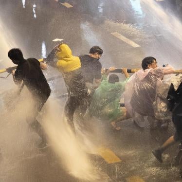 Pro democracy demonstrators face water canons as police try to clear the protest venue in Bangkok, Thailand, Friday, Oct. 16, 2020. 