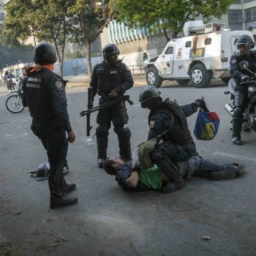 National Police detain an anti-government protester near the La Carlota airbase during clashes between opposition and government supporters in Caracas, Venezuela, on May 1, 2019.