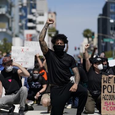 Demonstrators kneel outside the Long Beach Police Department in Long Beach, California during a protest on May 31, 2020. 