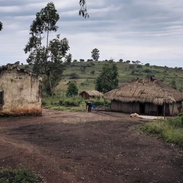 A man cleans his courtyard amidst ruins in Nioka, Ituri province, northeastern Democratic Republic of Congo, on September 15, 2020.