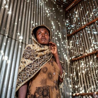 A woman stands in a metal sheet room that was damaged by shelling in Humera town, Tigray region, Ethiopia, on November 22, 2020. In that residential compound, two women and an elderly man were killed by shelling and gunfire, and two women were wounded.