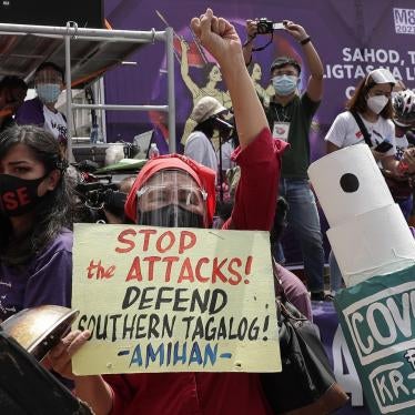 Protesters display slogans condemning the recent government attacks on activists during a rally near the Malacanang presidential palace on March 8, 2021 in Manila, Philippines.