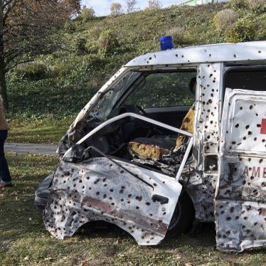 An ambulance covered in bullet holes 