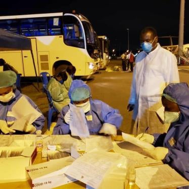 CDC Cameroon Associate Director for Program and Science, Dr. Clement Ndongmo, observes Covid-19 testing procedures for passengers arriving at Nsimalen International Airport in Yaoundé. 