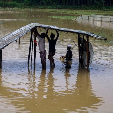Rohingya refugees repair a shelter damaged following heavy rains at the refugee camp in Kutupalong, Bangladesh on July 28, 2021.