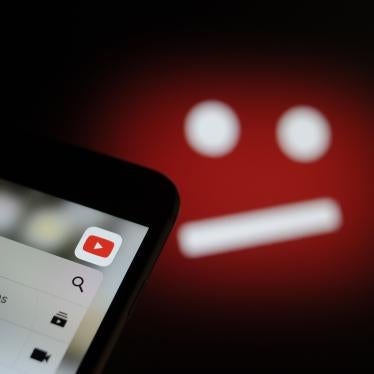 The YouTube video sharing application is seen on an iPhone with the symbol for unavailable content in the background in this photo illustration