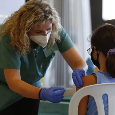 A nurse with a syringe explains and calms a girl while the COVID-19 vaccination goes on for children and young people in Granada, Spain on September 03, 2021. 
