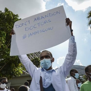 Healthcare workers protest outside the Ministry of Health headquarters in Nairobi, Kenya to honor one of their colleagues, Dr. Stephen Mogusu, a 28-year-old health worker who succumbed to Covid-19.