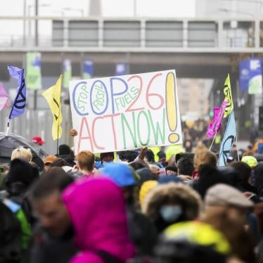 12 November 2021, United Kingdom, Glasgow: A poster calling for better climate protection is held aloft during a protest outside the grounds of the UN Climate Change Conference COP26. Photo by: Christoph Soeder/picture-alliance/dpa/AP Images