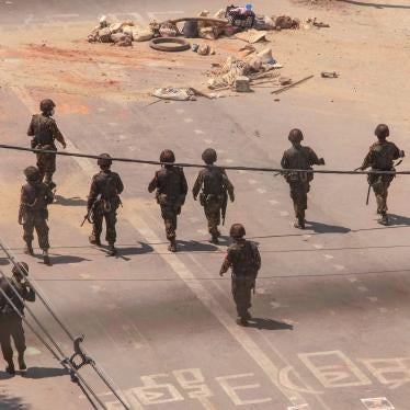 Myanmar military advance towards protesters during a demonstration against the military coup.