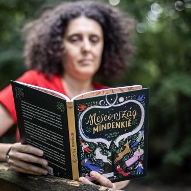 A woman reads from a book