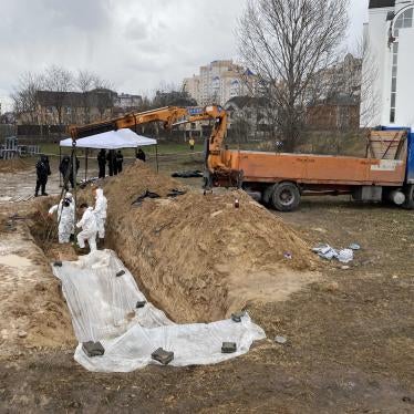 Ukrainian authorities in Bucha exhume bodies from a mass grave