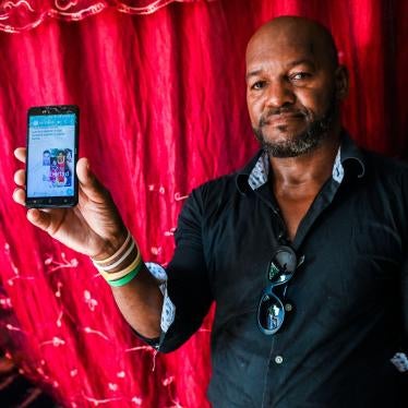 Emilio Roman, father of two young men and a daughter who were imprisoned and accused of participating in the July protests against the government, shows a picture of his children at their home in La Güinera neighborhood of Havana, March 29, 2022.