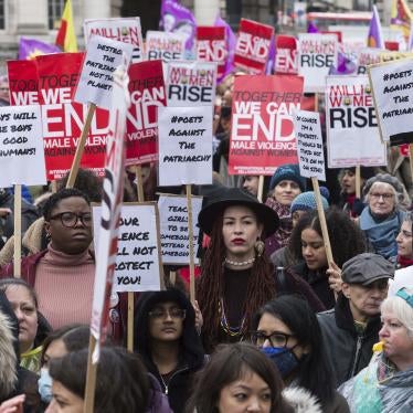Women hold placards at the Million Women Rise march in London ahead of International Women's Day on March 05, 2022. 