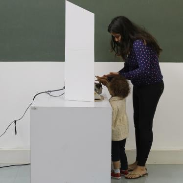 A woman, accompanied by a child, casts her ballot in the municipal election in Sao Paulo, Brazil, Sunday, Oct. 2, 2016.