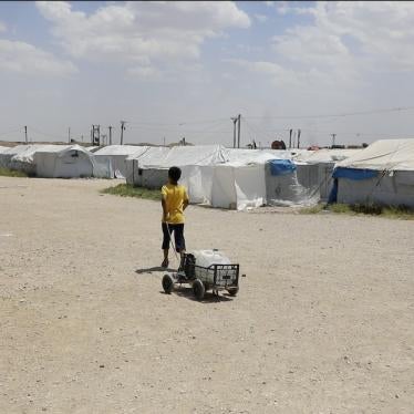 A boy lugs water in Roj camp in northeast Syria.