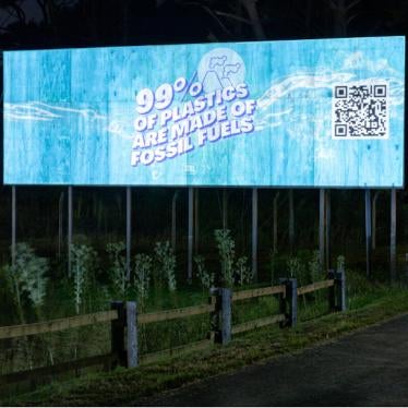 Greenpeace projects messages and plastic waste imagery on a billboard in Uruguay.