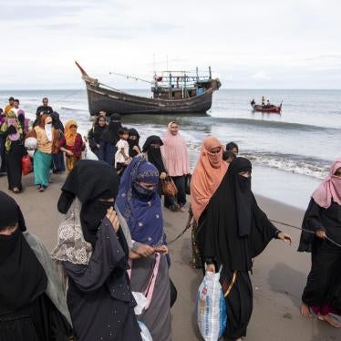 Ethnic Rohingya walk to a temporary shelter after they landed by boat in North Aceh, Indonesia.