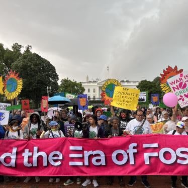On Earth Day, marchers at the Whit House hold  a banner reading, “End the Era of Fossil Fuels” Washington, DC.